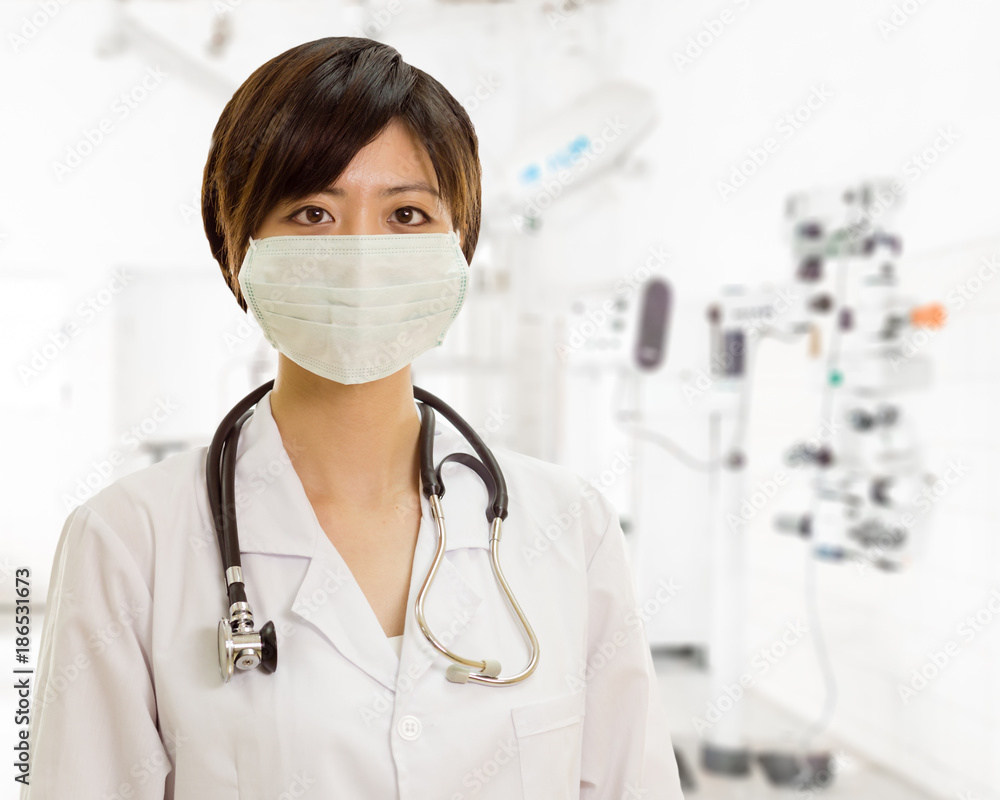 Asian female doctor with surgical mask looking at camera in clinic lab Asian female doctor with surgical mask looking at camera in clinic lab