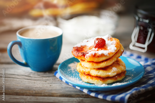 Delicious pancakes on wooden table with Cup of coffee and jam