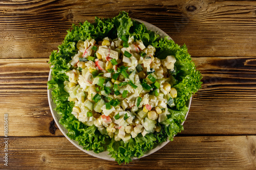 Salad with crab sticks, sweet corn, cucumber, eggs, rice and mayonnaise