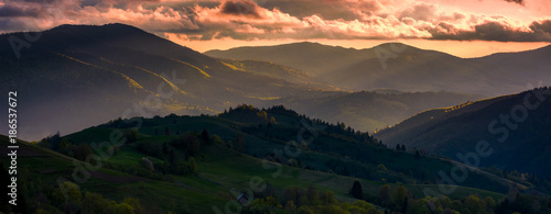 red sunset in mountainous countryside. gorgeous panorama of Carpathian mountains with cloudy sky in springtime