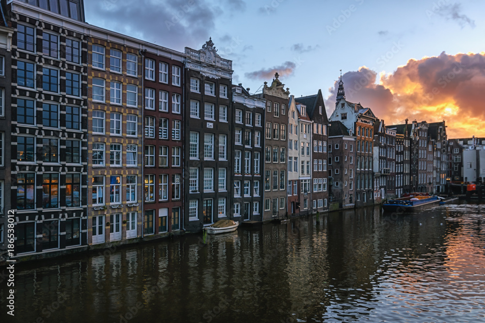 The characteristic canal houses on the Damrak in the old town of Amsterdam