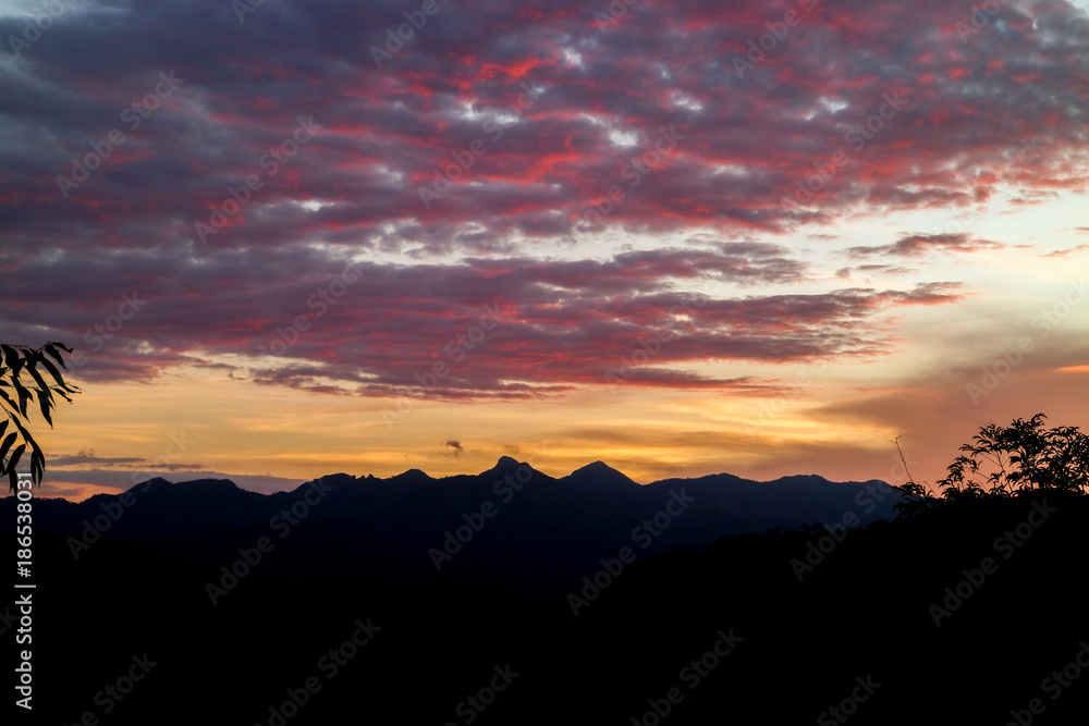 The ridge is a black silhouette. Sunset time. Use as background. The ridge is a black silhouette. Sunset time. Use as background.