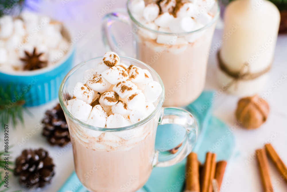 Hot cocoa with marshmallow and ground cinnamon in glasses on the table