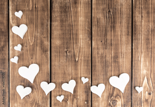 frame with hearts on a wooden background