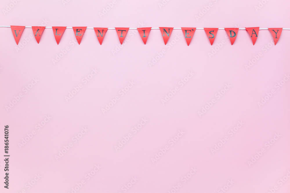 Table top view aerial image of Valentine 's day background concept.Valentines flag or Party banner on modern rustic pink wallpaper at home office desk studio.free space for creative design mock up.