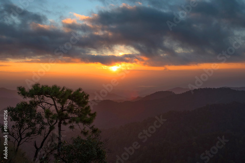 Landscape of beautiful sunset, sunrise the sun, fog and cloud are on the top of mountains, favor place for tourism who like hiking or trekking to see view, Doi Langka Lung, Thailand 