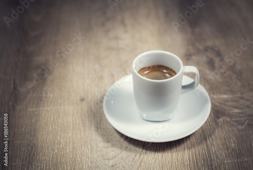 A cup of coffee on natural wood table