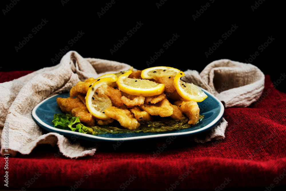 Chinese food fried fish and lemon slices