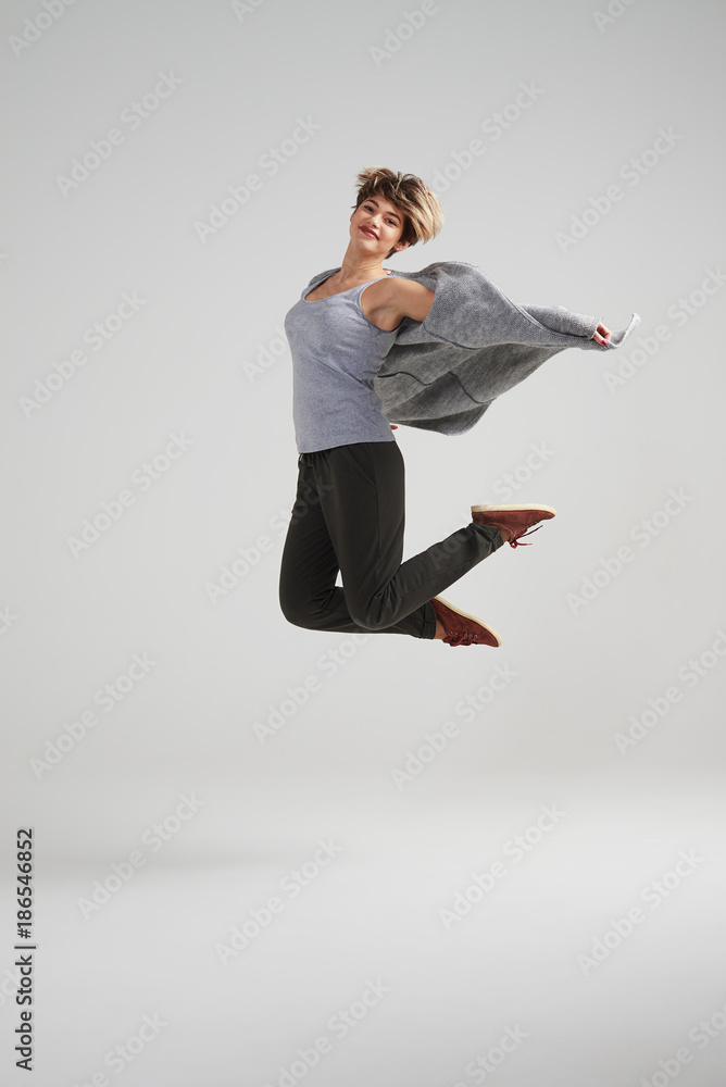 Cheerful woman jumping isolated on white background
