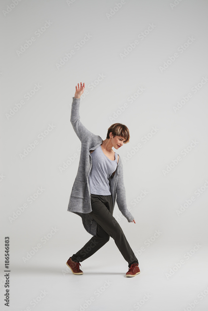 Young energetic girl raising while posing at studio Young energetic girl raising while posing at studio