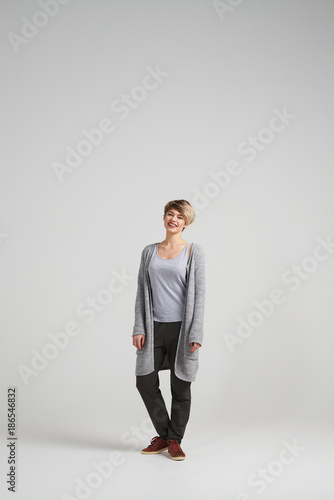 Attractive woman wearing cardigan posing at studio