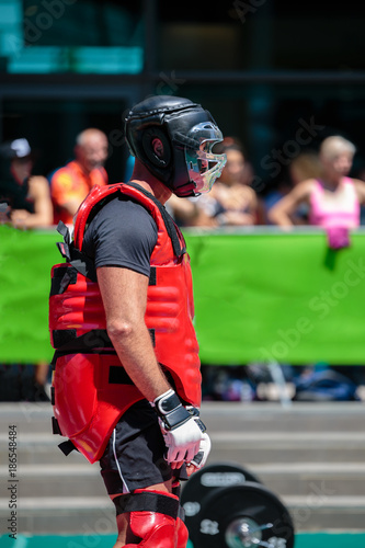 Extreme Sport: People Fighting Outdoors with Red Body Protective Gear