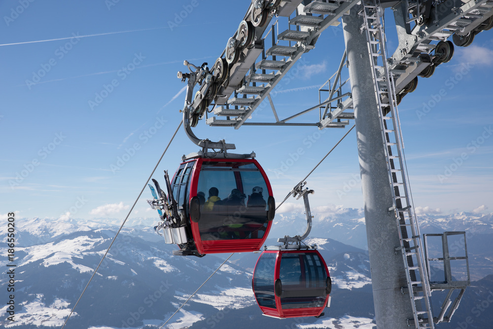 some skiing people in a funicular cahir lift are going to the top of the mountain to do some winter sport some skiing people in a funicular cahir lift are going to the top of the mountain to do some winter sport