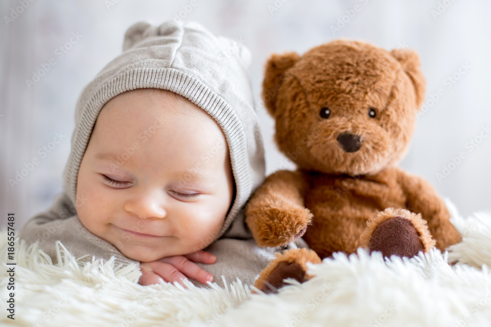 Sweet baby boy in bear overall, sleeping in bed with teddy bear Stock Photo  | Adobe Stock
