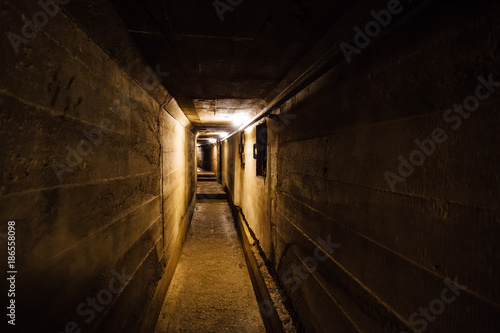 Dark corridor of old underground Soviet military bunker under artillery fortification. © Mulderphoto