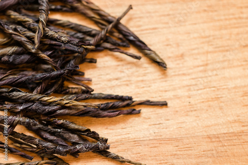 Dried black tea leaves on the table close up