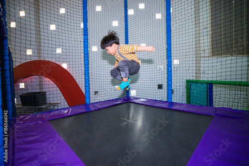 A kid is jumping on trampoline