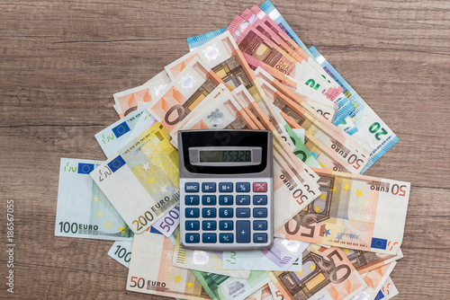 pen calculator and euro banknotes . close up