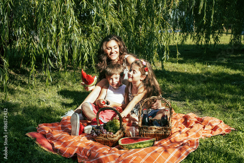 cute happy family on picnic laying on green grass mother and kid