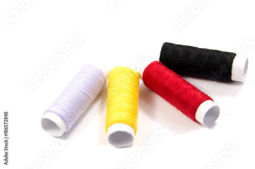 Colorful spools of thread isolated on white background
