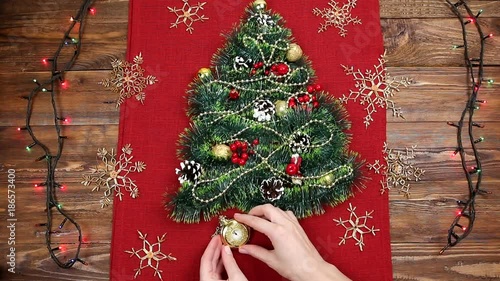 a small Christmas tree of tinsel, nuts, ribbons and ornaments. Gift for a Christmas tree, a vintage watch. 2018,