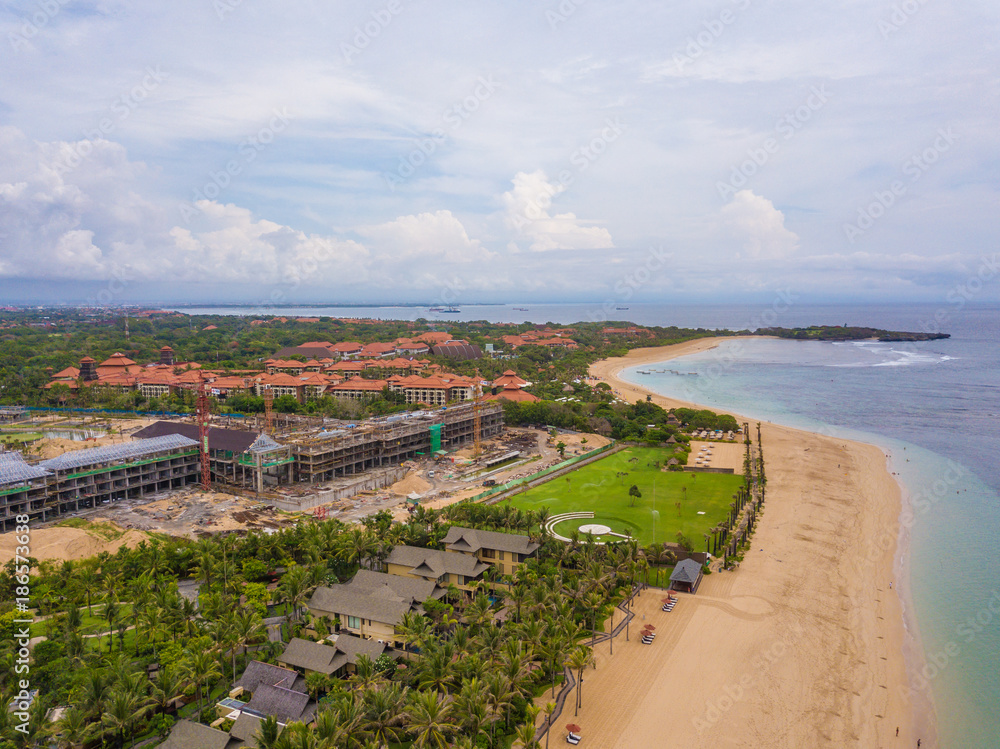 Aerial view of Nusa Dua beach and new hotel construction from drone, Bali island, Indonesia