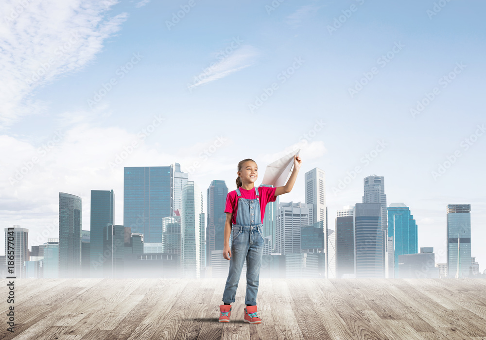Concept of careless happy childhood with girl dreaming about future Concept of careless happy childhood with girl dreaming about future