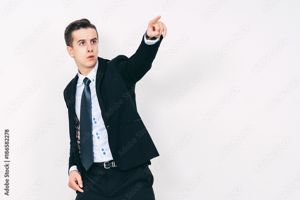 Portrait of a young businessman pointing at something interesting on a white background Portrait of a young businessman pointing at something interesting on a white background