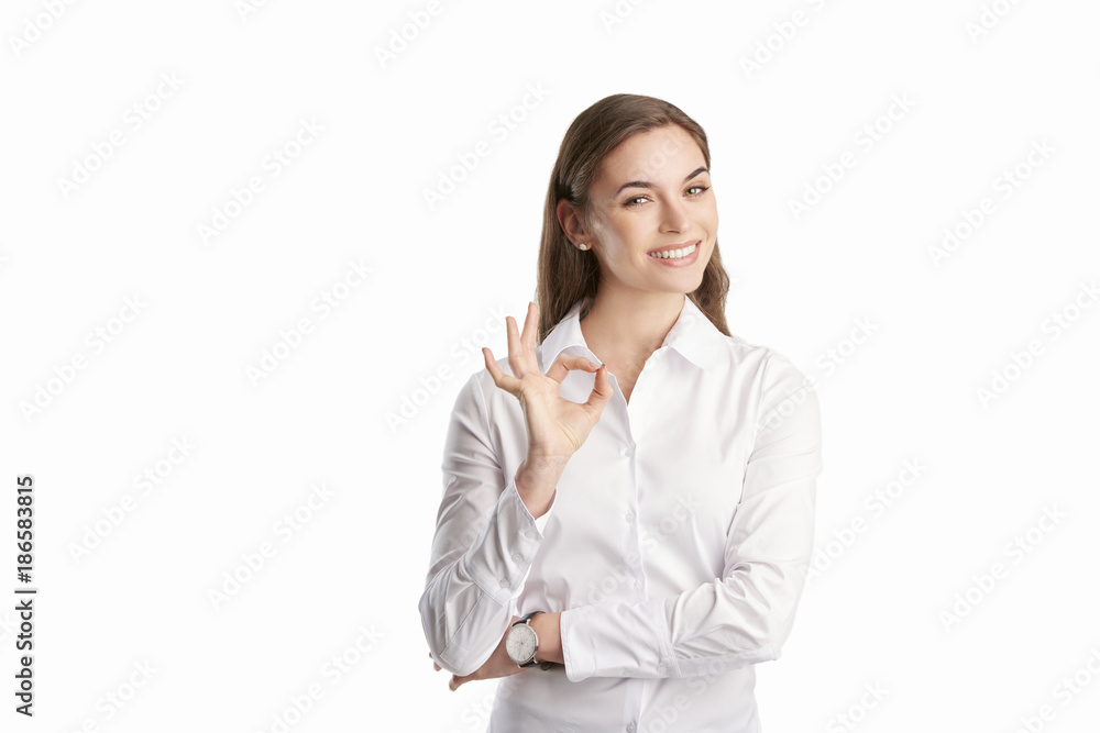 Everything is perfect at the business life. Beautiful young woman gesturing okay sign. Everything is perfect at the business life. Beautiful young woman gesturing okay sign.