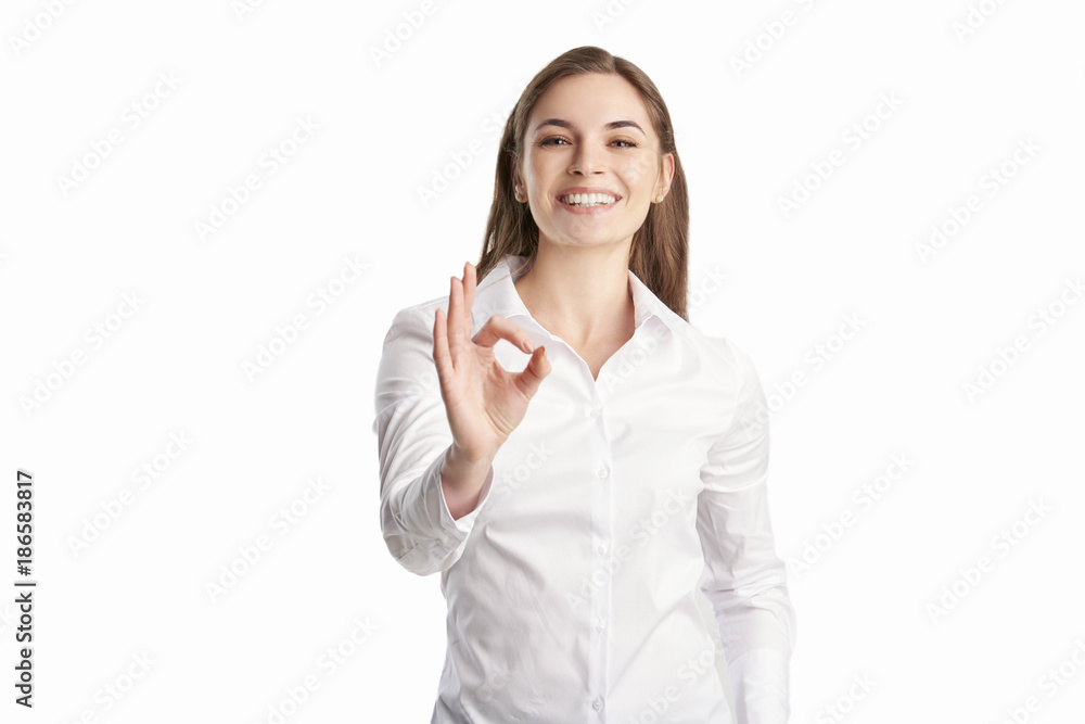Everything is perfect at the business life. Beautiful young woman gesturing okay sign. Everything is perfect at the business life. Beautiful young woman gesturing okay sign.