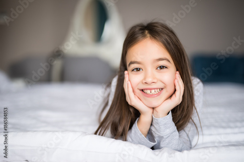 Free Download Sweet little girl is going to sleep in a bed at home - GFXLoad