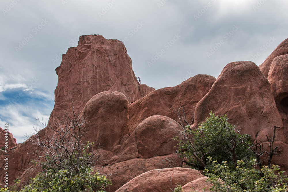Distant mountain climber red rocks Distant mountain climber red rocks