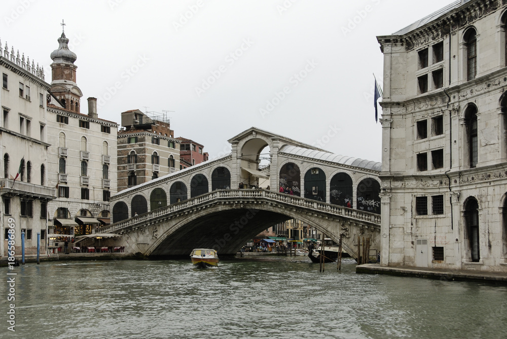 The famous Rialto Bridge (Ponte di Rialto) is one of the four bridges spanning the Grand Canal in Venice, Italy