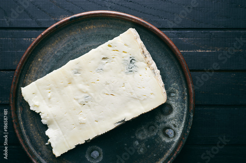 Fresh organic Italian cheese Gorgonzola on plate top view photo