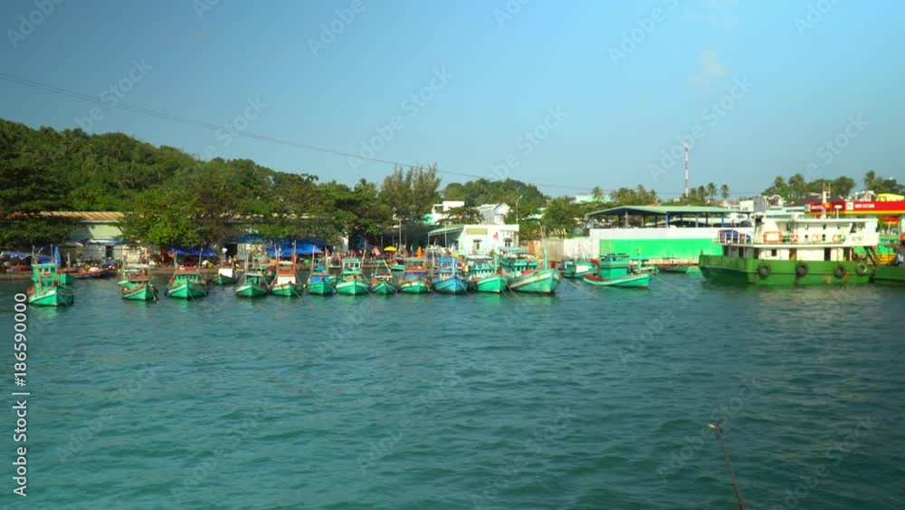 The village in Vietnam. The island in Vietnam. Boats on pier. A large number of traditional fishing boats around the station. The village in Vietnam. The island in Vietnam. Boats on pier. A large number of traditional fishing boats around the station.