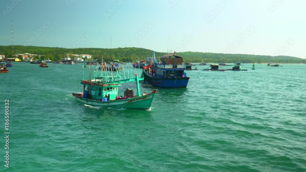 Boats float from pier on fishing. The island in Vietnam. A large number of traditional fishing boats Boats float from pier on fishing. The island in Vietnam. A large number of traditional fishing boats
