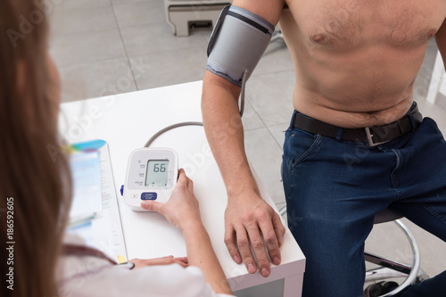 Doctor checking blood pressure 