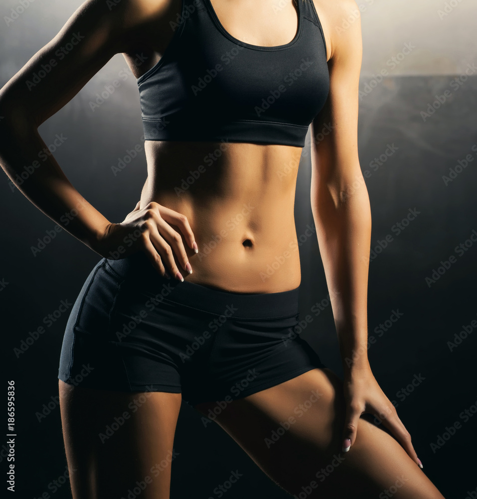 Beautiful woman body In shape. Healthy girl with fit slim body, soft skin.  Flawless woman in on grey background. Photo of girl with slim toned body.  Beauty and body care concept Stock