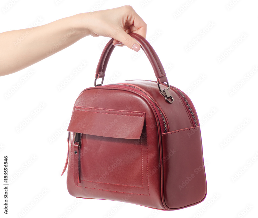 Naklejka premium Red burgundy leather bag in female hands