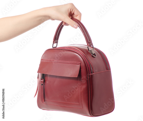 Red burgundy leather bag in female hands