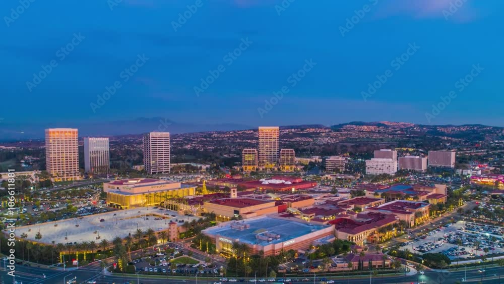 Aerial time lapse in motion of busy shopping mall at night