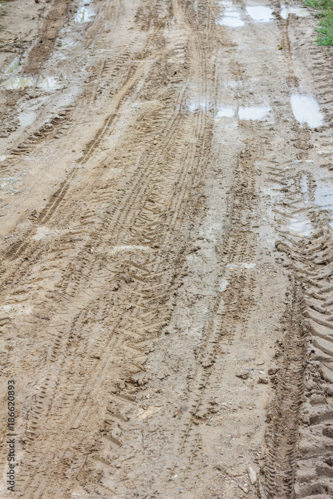 Wheel Off-road track in a countryside landscape with a muddy road / Extreme path rural dirt road in the hills / Muddy ground after rain. Wheel Off-road track in a countryside landscape with a muddy road / Extreme path rural dirt road in the hills / Muddy ground after rain.