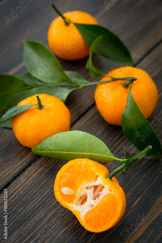 Sliced orange clementine tangerine fruit with green leaf