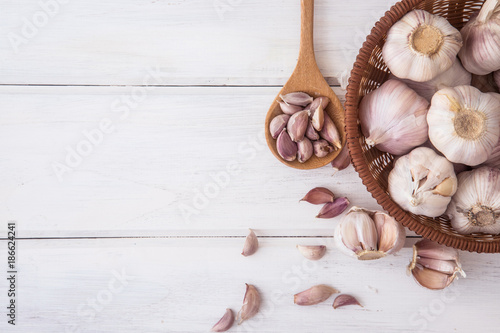 Close up a group of garlic on white wooden table board , top view or overhead shot with copy space