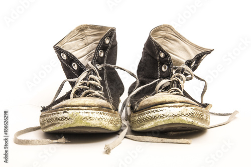 Pair of Men's or Teenager's Worn Out Dirty High Top Black and White Athletic Tennis Shoes Isolated on White Background