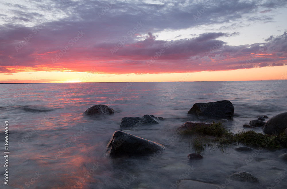 Beautiful sunset over the balitc sea after a summers day, the sun is reflecting on the water surface