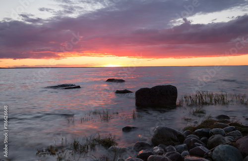 Beautiful sunset over the balitc sea after a summers day, the sun is reflecting on the water surface © Henrik Larsson