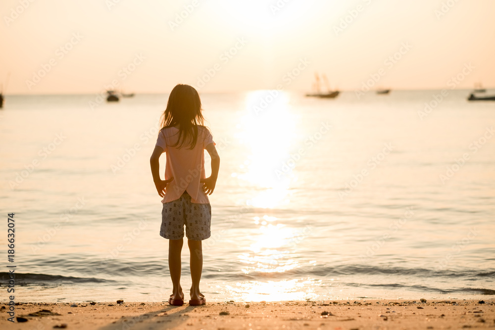 travel background girl stand alone on beach looking beautiful sea sunset. image for person, nature, portrait, landscape, scenery, evening concept