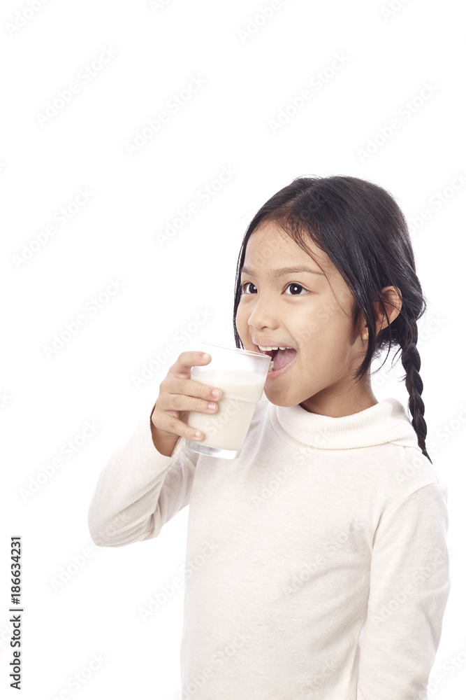 Preschool girl holding a glass with milk Preschool girl holding a glass with milk