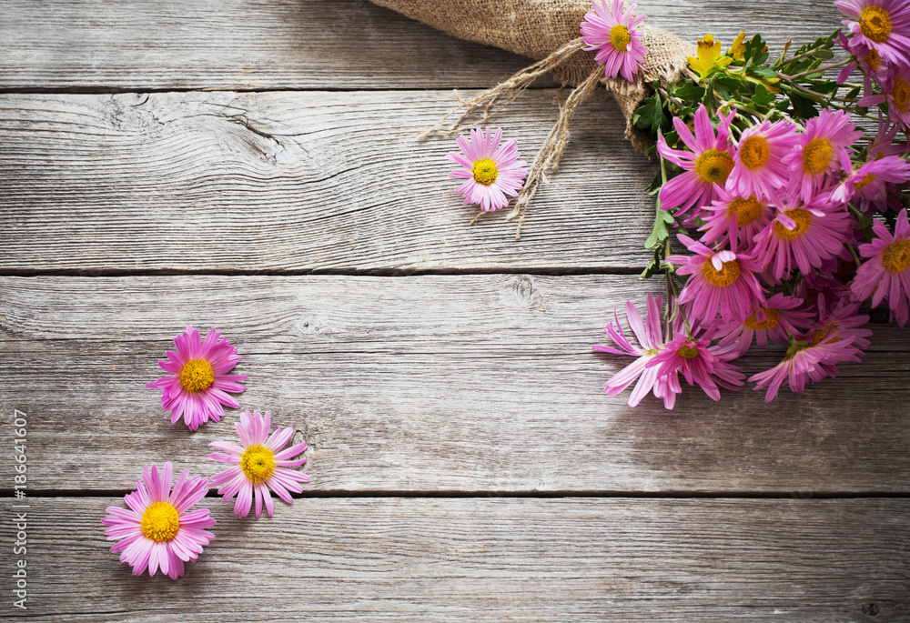 pink flowers on old wooden background pink flowers on old wooden background